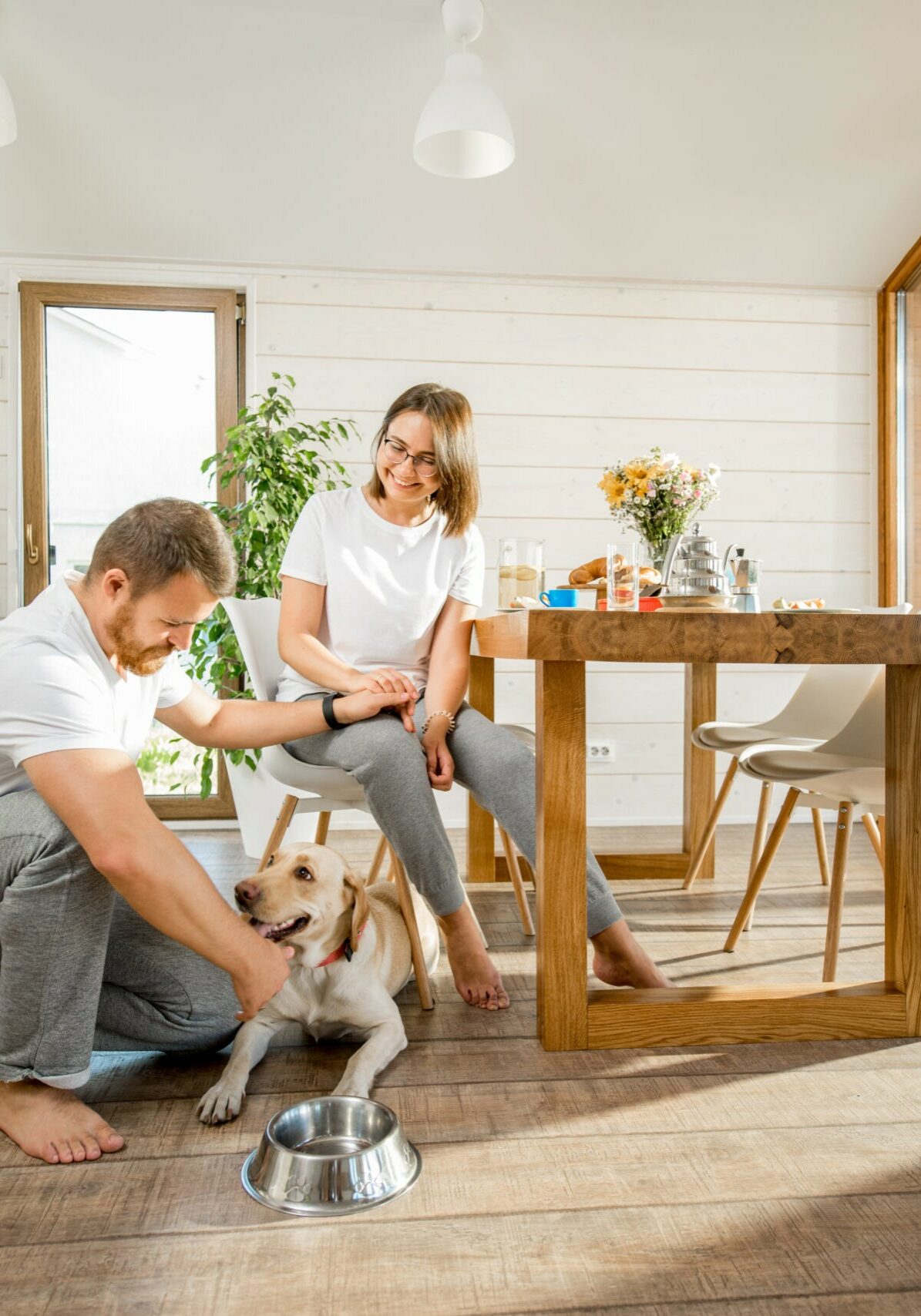 Young couple with dog at home | Sotheby Floors