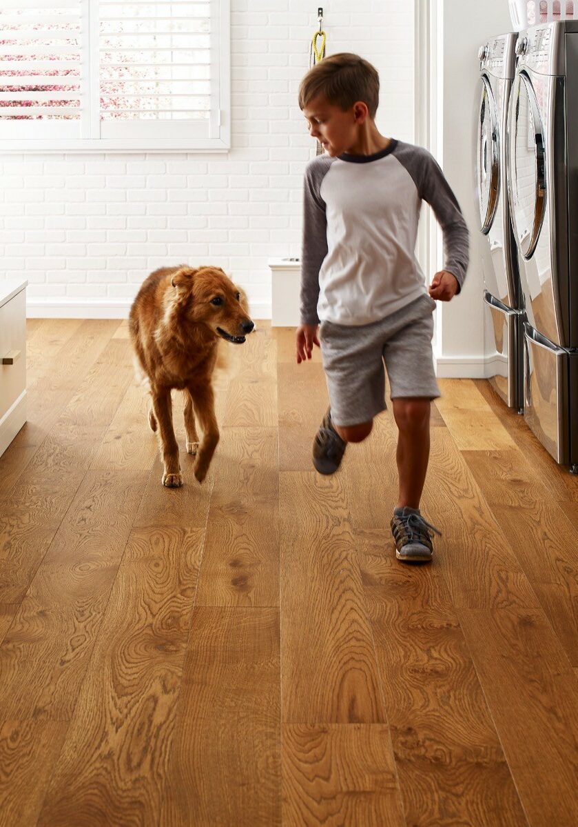 Dog running with kid | Sotheby Floors